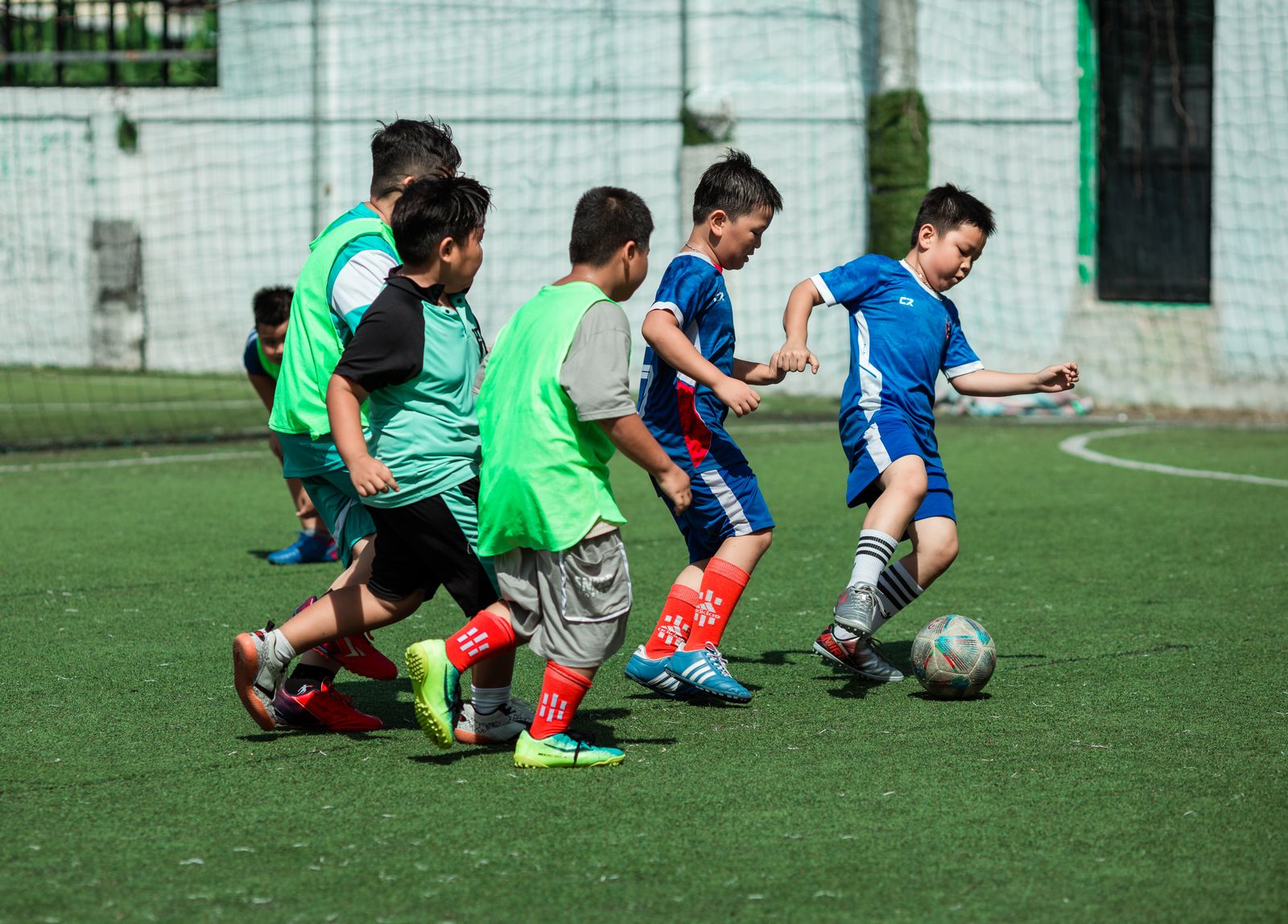 Children playing youth soccer on a grass field