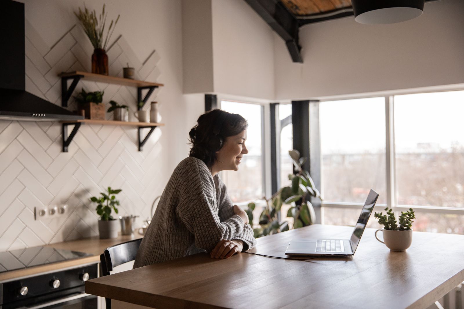 A parent on a laptop video call at home